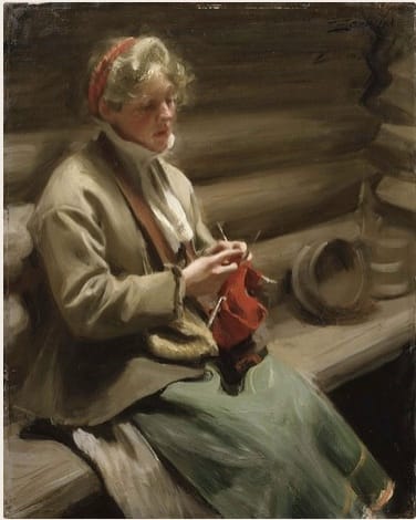 Woman in a red headband, brown coat, and long green skirt, sits on a rustic bench, knitting red yarn with double-pointed needles.